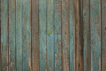 old turquoise dilapidated wooden fence