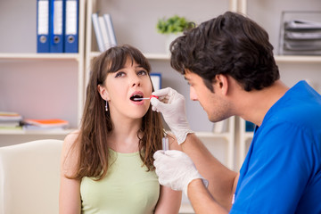 Young woman visiting male doctor dentist for removal of tartar 