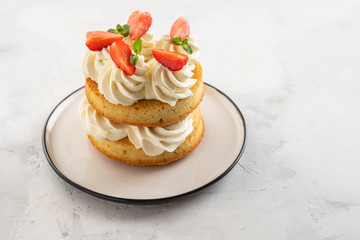 Strawberry cake with vanilla cream on white background. Copy space.