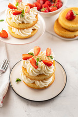 Strawberry cake with vanilla cream on white background. Copy space.