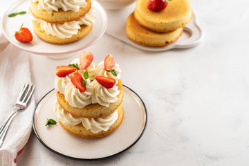 Strawberry cake with vanilla cream on white background. Copy space.