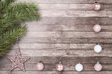 Christmas fir-tree and toys on wooden background.