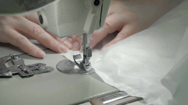 Close up view of sewing machine making stitch on fabric fashion clothes