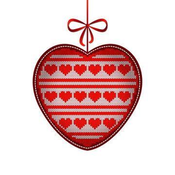 Valentines Day. Knitted texture in the shape of a heart. Pattern of hearts and stripes. White and red. Hanging on a string with a bow.