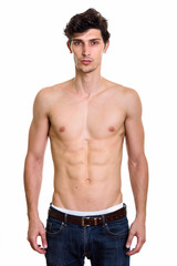 Fototapeta premium Studio shot of young handsome man standing shirtless