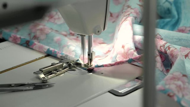 Close up view of sewing machine making stitch on fabric fashion clothes