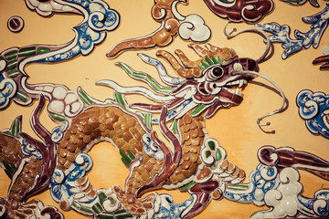 Detailed view of dragons on Citadel the Imperial City with the Purple Forbidden City in Hue, Vietnam.