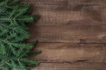 Fir tree branches. Christmas background concept. Border and copy space on wooden boards.