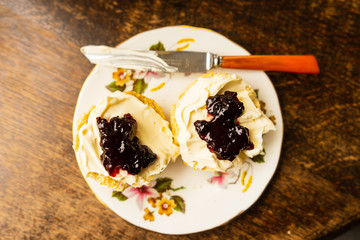 Traditional British scone with clotted cream and jam from above