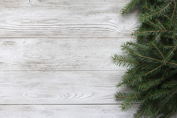 Fir tree branches. Christmas background concept. Border and copy space on white wooden boards.