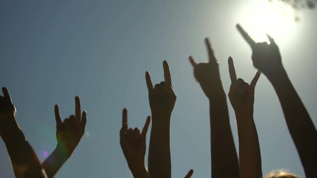 Raised hands showing rock sign of the horns gesture, rock concert, party time