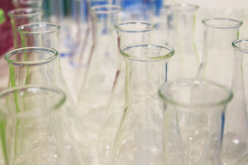 Flasks close up equipment in laboratory background. Glass bottle in science experimental research.