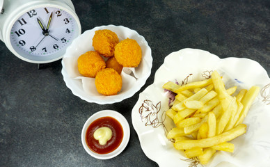 French Fries and Cheese ball, tomato sauce in a white dish on a stone floor table,Top view with copy space for your text..