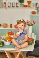 Family Thanksgiving Day.Baby in kitchen.Tanksgiving celebration table with traditional festive food. Tanksgiving celebration dinner setting meal concept. Halloween Pumpkins.Autumn feast.Mothers Day