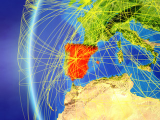 Spain from space on model of Earth with international network. Concept of digital communication or travel.