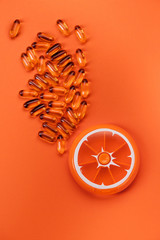 omega-3 softgel capsules and pillbox, flat lay