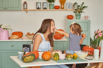 Family Thanksgiving Day. Family in kitchen.Tanksgiving celebration table with traditional festive food. Tanksgiving celebration dinner setting meal concept. Halloween Pumpkins.Autumn feast.Mothers Day