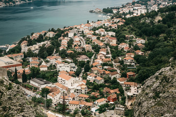 Naklejka premium Aerial view of Kotor - a city on the Adriatic coast in Montenegro. One of the most beautiful coastal cities of Montenegro. Near a beautiful mountain landscape.