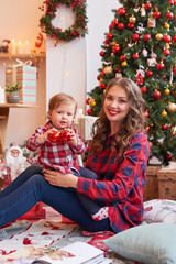 Obraz na płótnie Canvas Christmas family Mom and daughter. Merry Christmas and Happy Holidays card! Morning before Xmas background. Portrait loving family. Family preparation holiday food. Happy New Year! Christmas baby