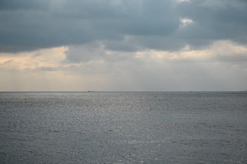 Fototapeta premium a calm sea and a skyline separating clouds