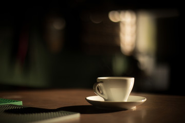 Color image of some steam coming out of a coffee cup.