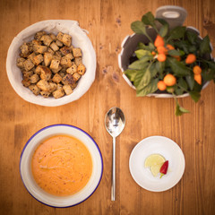 Orange creamy soup with croutons