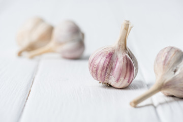 Garlic bulbs on white wooden table