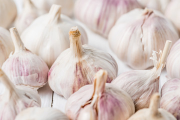Ripe garlic bulbs on white kitchen table