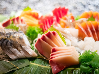 Assortment of tasty and delicious Sashimi or sliced raw fish and seafood. Most popular Japanese food. Low in saturated fat, rich in omega-3 fatty acid and vitamin. Healthy eating and eat well concept.