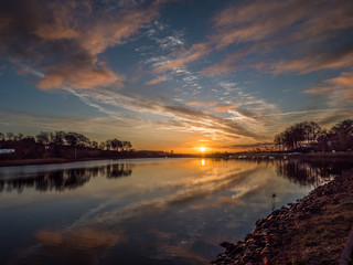Image of a marina with water reflection and dramatic sky.