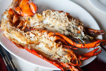 Simple yet delicious. Hot and freshly Grilled halved Lobster with butter. Fresh, juicy and tasty bright red Maine Lobster or American lobster. Sweet and flavorful lobster. Rich in omega-3 fatty acid