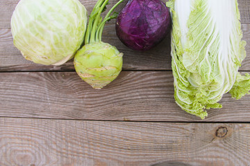 Set of different type of cabbage on rustic wooden table