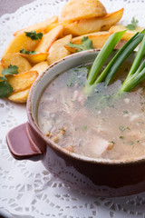 Wild forest mushrooms soup served with fried potato