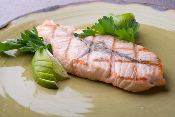 Steamed salmon steak served with lime