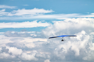Light aircraft, deltaplane, against the sky with white clouds. deltaplane