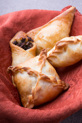 Different baked pirogi or samosa