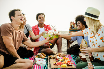 Diverse friends enjoying a beach picnic