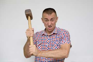 Aggressive man with a sledgehammer on a white background. Work concept