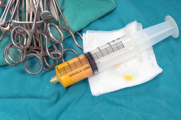 Close up fat syringes on the green surgical drapes for fat grafting or fat transfer procedure