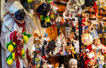 Statues of pulcinella lucky charm and red horns at the souvenir shop in Naples