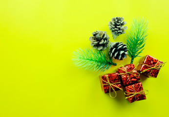 Christmas Decorations on yellow art paper background and have copy space.