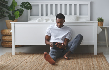 happy young african american black man with tablet in morning - Powered by Adobe
