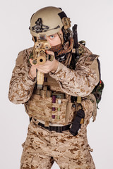 Special forces United States soldier or private military contractor holding rifle. Image on a white background.