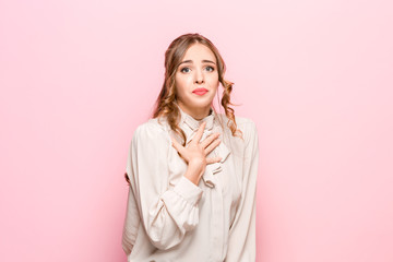 Indoor shot of regretful woman looks gloomy and desperate, Cute adorable girl pleads about...