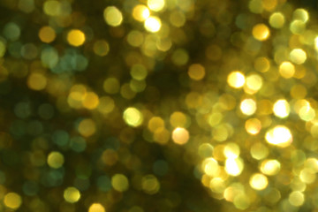 Christmas abstract gold bokeh background with light color in blur.