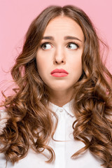 Fototapeta premium Indoor shot of regretful woman looks gloomy and desperate, Cute adorable girl pleads about something.