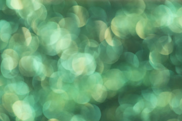 Christmas abstract green bokeh background with light color in blur.