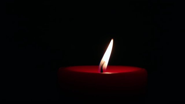 Close up of red candle light and being blown out