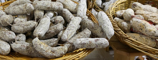 many salamis on sale in the Italian delicatessen