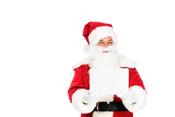 santa claus holding laptop and looking at camera isolated on white